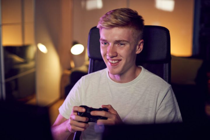 teenage-boy-with-game-pad-sitting-in-chair-and-gam-2024-10-19-10-32-46-utc-768x512.jpg